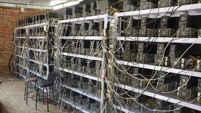 A large-scale mining farm with rows of miners and powerful cooling systems