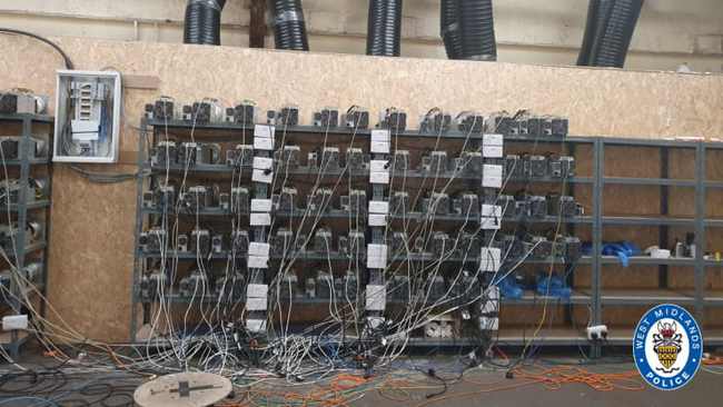 Crypto mining farm with rows of mining machines